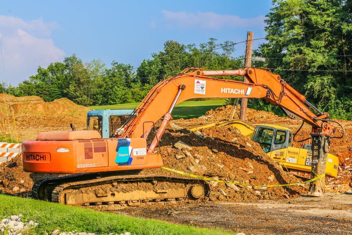 backhoe excavator digging trench