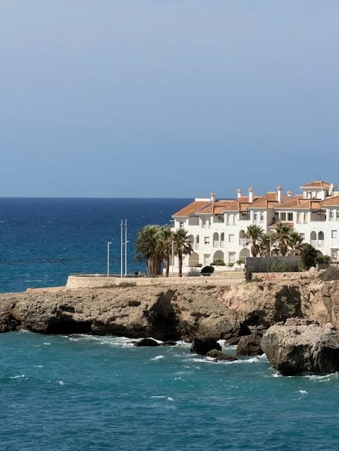 "Charming coastal home with a sunlit veranda and colorful garden, highlighted in 'Top 10 Beach Homes You Must See Before 2025!'"