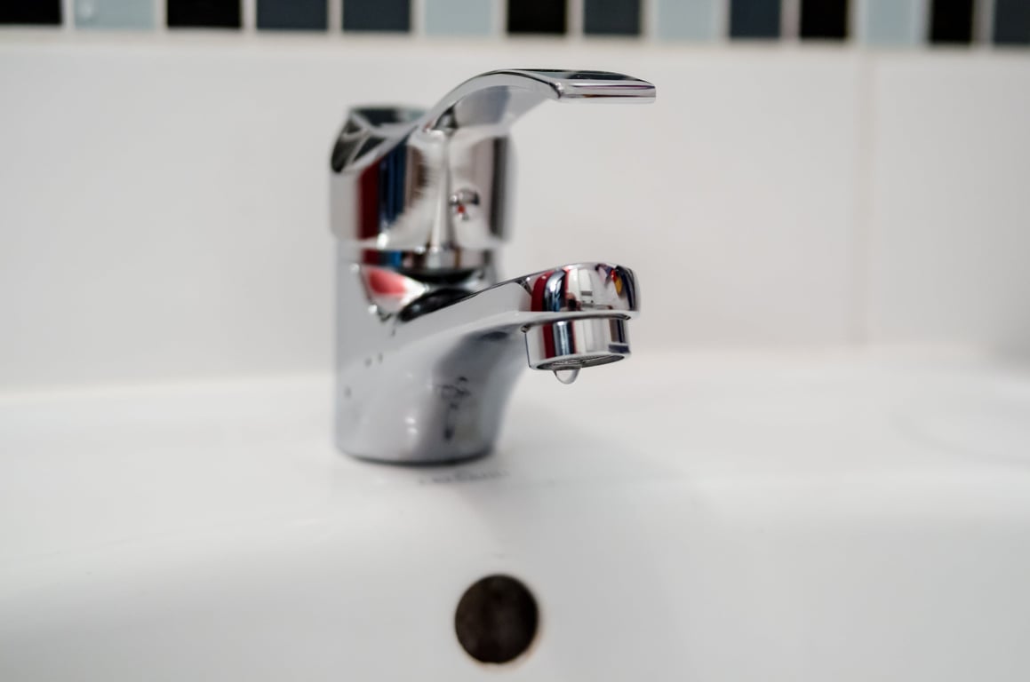 plumber unclogging sink drain