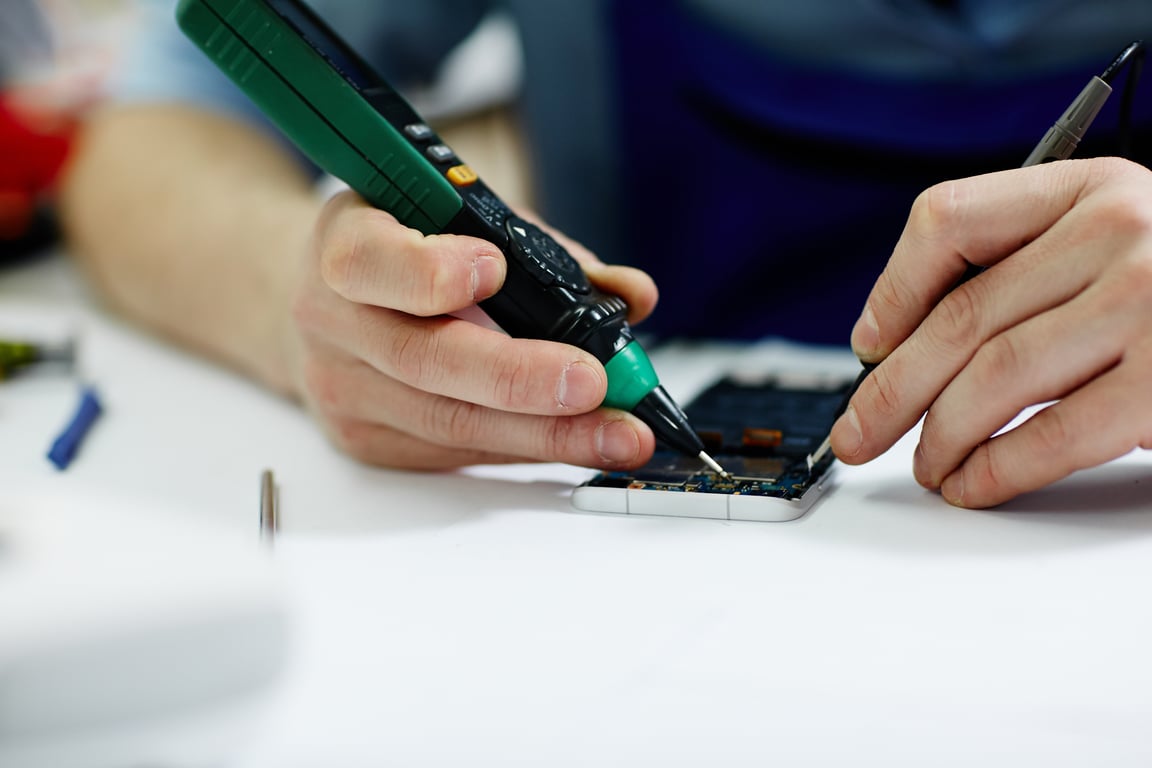 HVAC technician repairing air conditioner