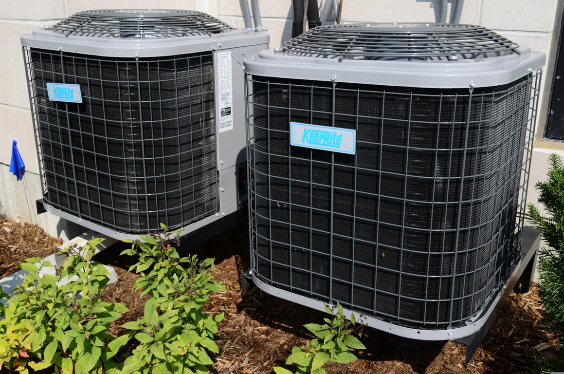 HVAC technician repairing air conditioner