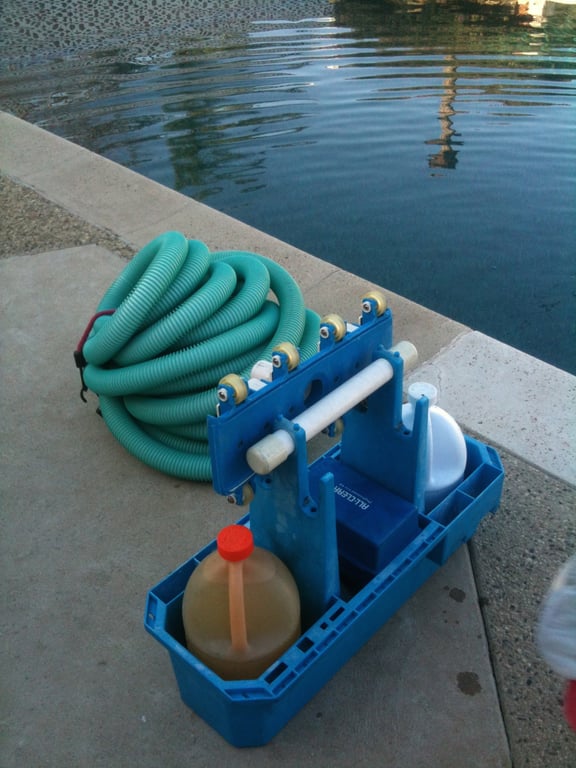 pool service technician cleaning skimmer