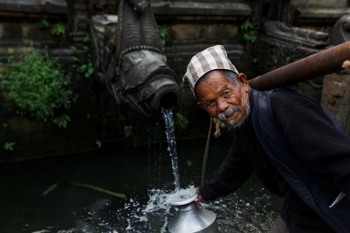 elderly person drinking water