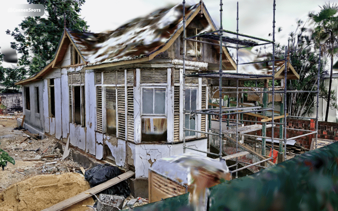 Wooden gingerbread façade under construction with fretwork details