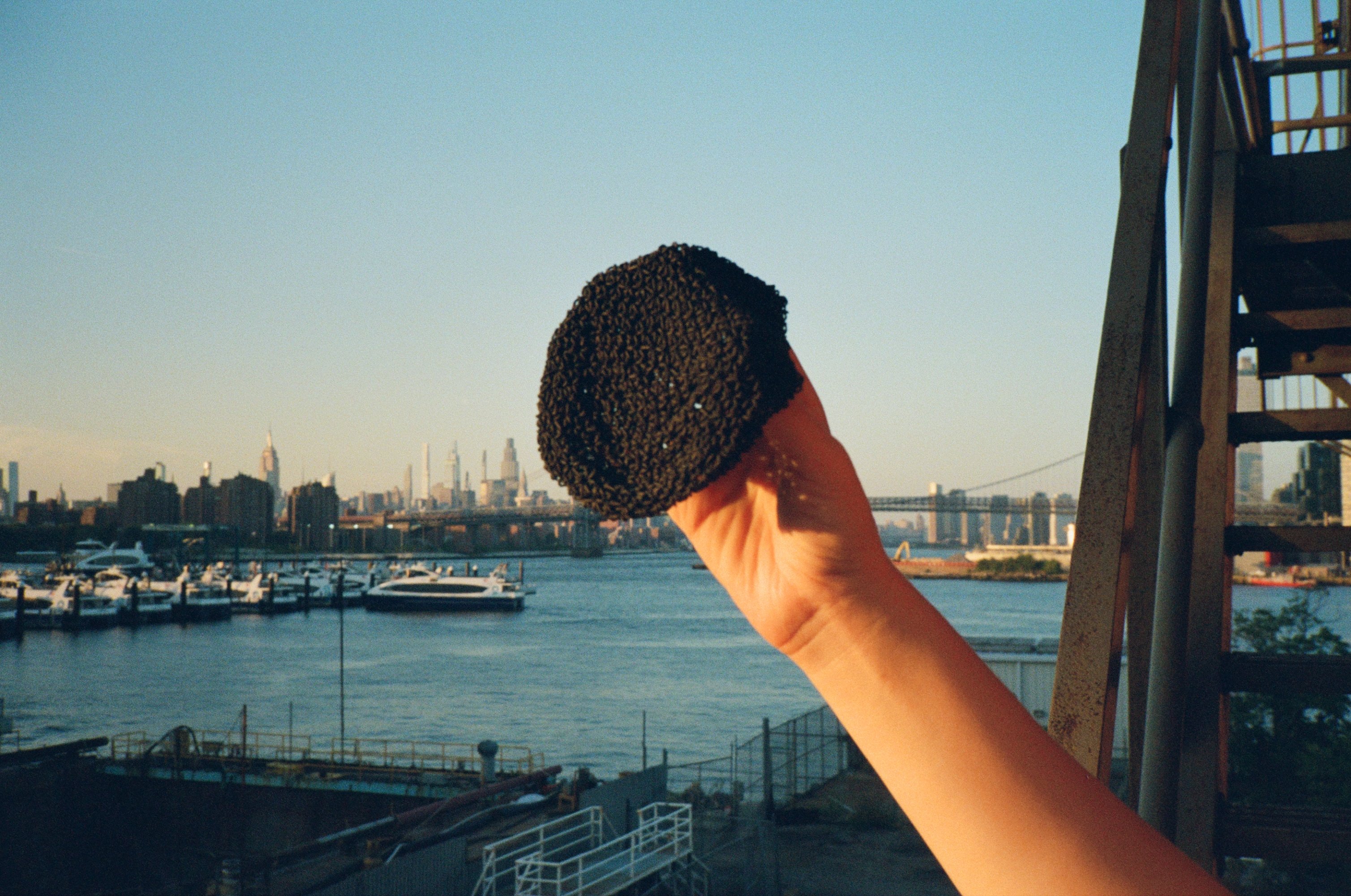 A black Chainmesh Sphere held up against the sky