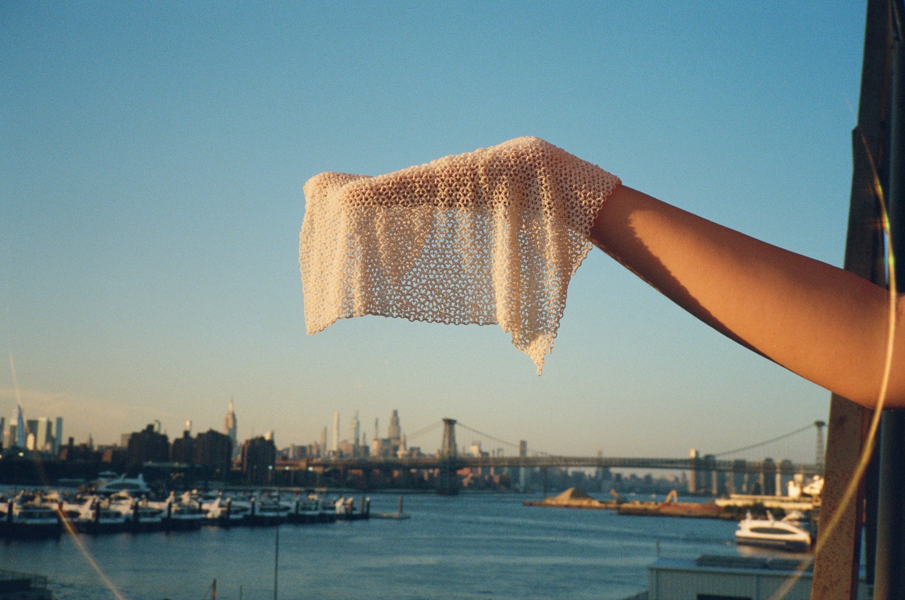 A sheet of chainmesh draping off a hand