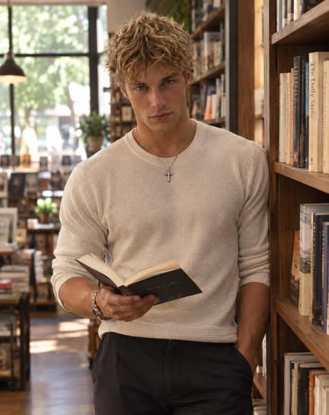 Turn my uploaded reference photo into a realistic, sophisticated dating-app photograph while preserving my exact identity.
Keep my exact facial structure, eyes, nose, lips, jawline, hairstyle, skin tone, body proportions and recognizable appearance.
Place me inside a cozy independent bookstore with tall bookshelves and warm natural window light.
I am standing casually beside a bookshelf, holding an open book in one hand while the other hand rests naturally in my pocket, looking toward the camera with a relaxed half-smile.
Make the pose feel spontaneous, as if someone accompanying me took the photograph naturally.
Dress me in a simple textured knit or fitted casual shirt with dark trousers and minimal accessories.
Use warm ambient lighting mixed with soft daylight from the windows.
Background bookshelves should be realistic and slightly out of focus.
Preserve natural skin texture, subtle facial imperfections, realistic hair strands, authentic clothing wrinkles, realistic hands and believable lighting.
The photograph should communicate calm, confident, approachable energy without looking staged.
High-end lifestyle photography, realistic DSLR look, natural colors, subtle film grain, shallow depth of field.
No studio lighting, no excessive retouching, no artificial intellectual pose, no fake smile, no AI-looking skin.
