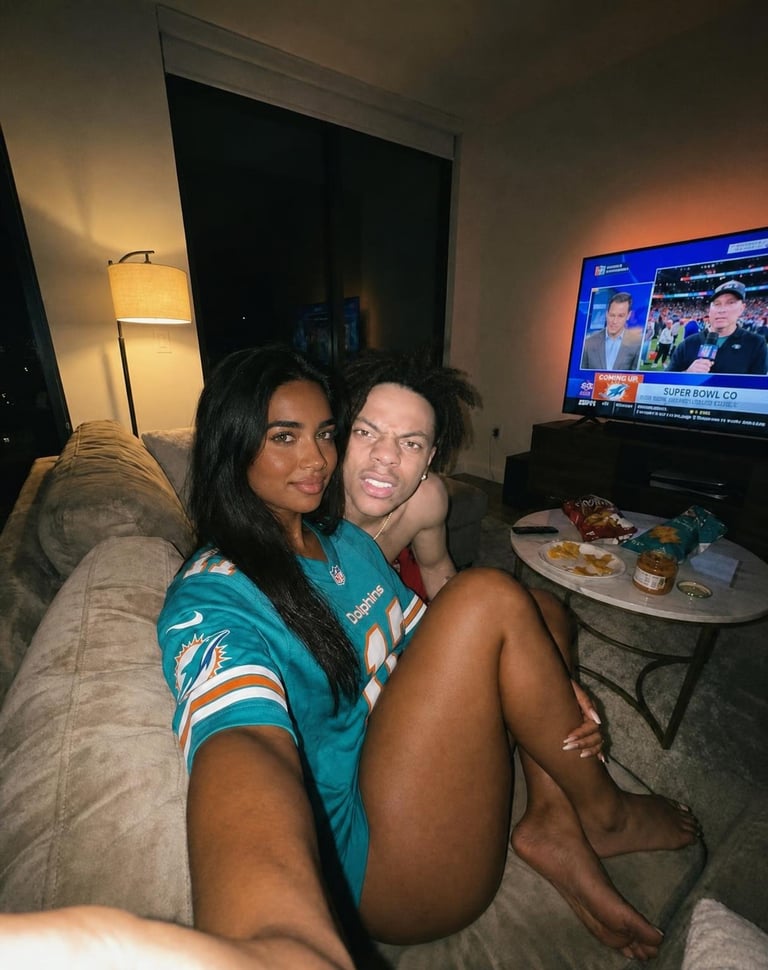 Swap ONLY the skin colours of the two people in this image. Keep the original ph