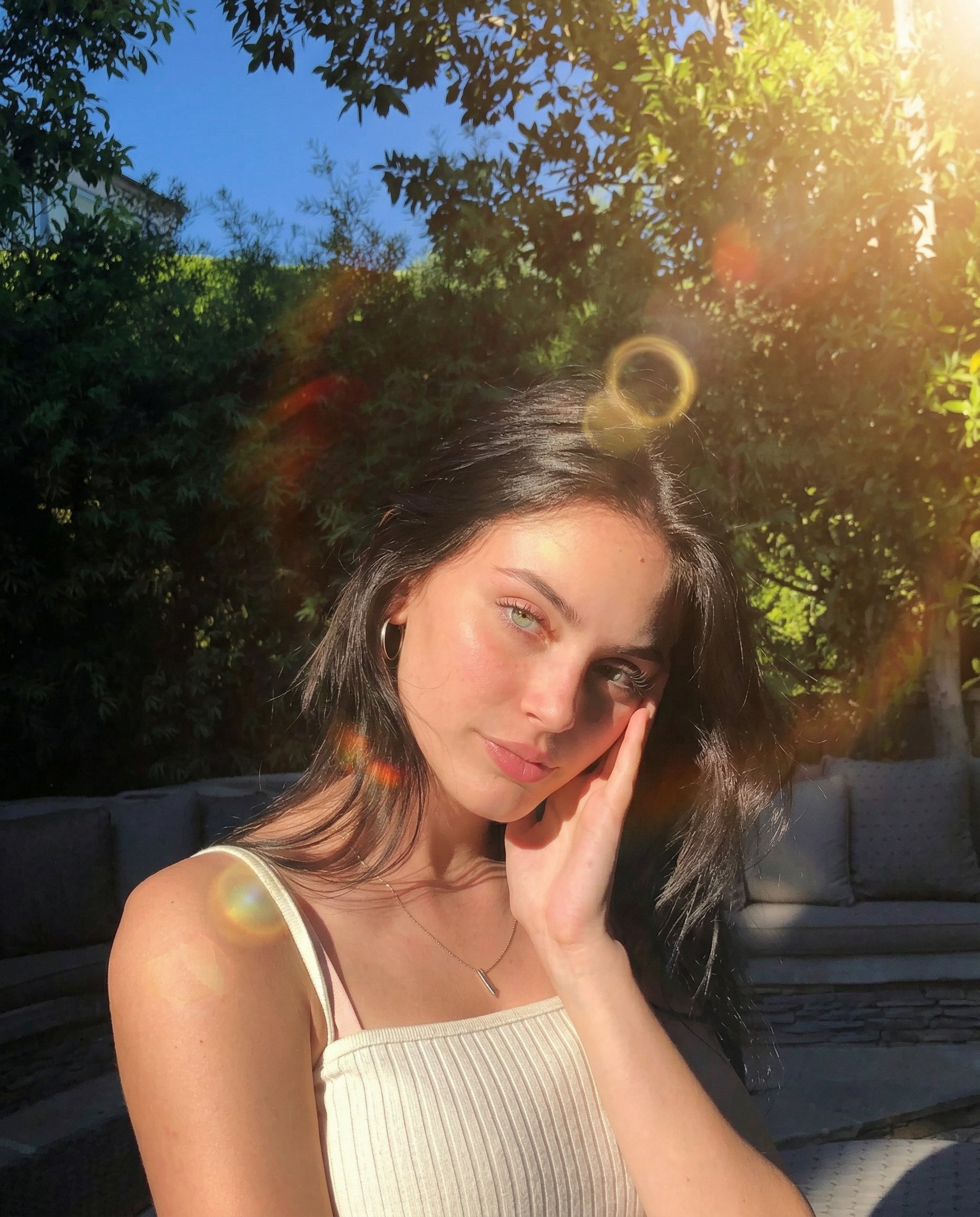 MODEL: nanobanana-2
TASK: image_transform
INPUT: uploaded_photo

GOAL
Apply a realistic sun flare lens effect while preserving the original photo exactly.

IDENTITY & SCENE LOCK
- Preserve the subject exactly
- Preserve facial features and body proportions
- Preserve pose and clothing
- Preserve camera angle and framing
- Preserve background and environment
- Do not change composition

TRANSFORMATION
Effect: natural golden sun flare filter

LIGHTING EFFECT
- Add warm golden sunlight entering the lens
- Create subtle lens flare streaks and light bloom
- Add soft glowing highlights around bright areas
- Simulate natural optical lens artifact
- Light direction should appear consistent with the scene

REALISM RULES
- Photorealistic color fidelity
- Natural lighting behavior
- No artificial overlays
- No stylized or cinematic grading
- No subject distortion
- No face or body modification

IMAGE QUALITY
- High resolution
- Preserve original textures
- Maintain natural skin detail
- Maintain original depth and perspective

RESULT
The final image should look identical to the original photo but with a subtle, realistic golden sunlight flare captured through the camera lens.