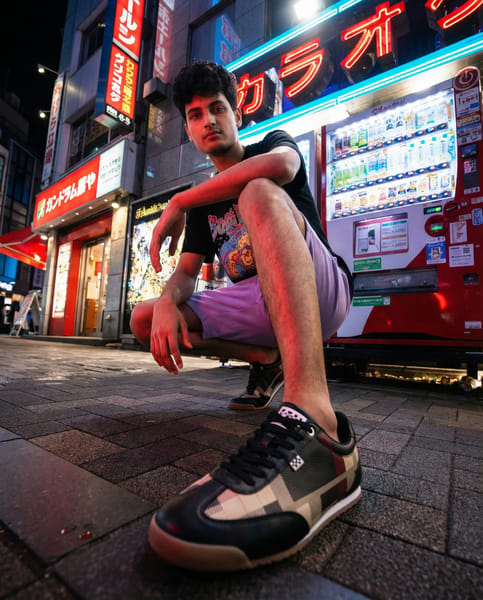 {
  "task_name": "Sneaker Try-On | A>C>B | Match Input B Style Exactly",
  "inputs": {
    "A": "sneaker product photo (single image) — product of truth",
    "B": "brand style reference photo (campaign look) — style of truth",
    "C": "user full body photo — identity of truth"
  },
  "role_map": {
    "priority_order": ["A_product_truth", "C_user_identity", "B_style_truth"],
    "A_product_truth": {
      "description": "Absolute source for sneaker identity. Never redesign.",
      "locks": [
        "shape",
        "proportions",
        "sole_thickness",
        "materials",
        "stitching",
        "colorway",
        "logo_design",
        "logo_placement",
        "logo_orientation",
        "logo_sharpness"
      ],
      "allowed": ["minor lighting adaptation", "minor reflection adaptation"],
      "forbidden": [
        "redesign",
        "logo distortion",
        "brand alteration",
        "blurred or unreadable logos",
        "added text/labels on sneaker"
      ]
    },
    "C_user_identity": {
      "description": "Absolute source for user identity (face + body). Must remain recognizable.",
      "locks": ["face identity", "body proportions", "skin tone"],
      "allowed": [
        "light commercial polish (natural contrast, clean rendering)",
        "minor artifact cleanup"
      ],
      "forbidden": ["face reshaping", "beauty-filter look", "identity drift"]
    },
    "B_style_truth": {
      "description": "Match Input B's visual language as closely as possible while keeping A and C locks.",
      "match_exactly": [
        "lighting direction/intensity",
        "color grading and contrast",
        "environment type and time-of-day",
        "camera angle and framing",
        "lens perspective/distortion level",
        "depth of field / background sharpness",
        "mood/attitude",
        "styling vibe (streetwear campaign)",
        "overall realism level"
      ],
      "do_not_copy": [
        "B person identity",
        "B face",
        "B body type",
        "B exact wardrobe items/branding text"
      ],
      "strength": "strong"
    }
  },
  "objective": {
    "goal": "Generate one 4:5 real commercial campaign photo where the user (C) is wearing the exact sneaker (A), and the entire photo style matches Input B (lighting/camera/environment/color/mood) as closely as possible.",
    "success_criteria": [
      "User remains clearly recognizable as themselves",
      "Sneaker from A is unchanged and logo is perfectly sharp/readable",
      "Photo reads as real commercial photography (no AI composite look)",
      "Sneaker is emphasized, but full outfit still looks good"
    ]
  },
  "composition_rules": {
    "pose": {
      "mode": "match_B_pose_language",
      "requirements": [
        "Adapt the user pose to match B's pose language (angle, attitude, weight shift) while staying natural for the user",
        "Do not replicate B pose 1:1 if incompatible with C anatomy or framing"
      ]
    },
    "clothing": {
      "preserve_user_clothing": true,
      "auto_adjust_only_for_visibility": [
        "pants hem fold/crop to expose sneaker cleanly"
      ],
      "forbidden": [
        "outfit replacement",
        "adding new garments",
        "adding brand logos or text"
      ],
      "style_requirement": "Make the existing outfit look intentional and campaign-ready via lighting, grading, and clean rendering (not wardrobe change)."
    },
    "sneaker_integration": {
      "replace_existing_footwear": true,
      "fit_and_scale": [
        "correct size relative to foot",
        "correct sole thickness per A",
        "correct perspective per B camera"
      ],
      "ground_contact": {
        "must_be_physical": true,
        "includes": ["correct shadow", "weight/pressure realism", "consistent perspective"]
      },
      "visibility": {
        "must_be_visible": true,
        "occlusion_policy": "keep_visible",
        "requirements": [
          "Ensure sneaker is unobstructed and visually readable",
          "Adjust clothing edges only if needed to keep sneaker visible"
        ]
      },
      "emphasis": {
        "priority": "high",
        "methods": [
          "composition frames sneaker clearly",
          "subtle perspective advantage consistent with B",
          "lighting highlights sneaker surfaces without blowing out logos"
        ]
      }
    },
    "camera_and_scene": {
      "source_of_truth": "B",
      "match": [
        "camera height and tilt",
        "framing and subject placement",
        "lens feel (wide vs normal)",
        "background density and bokeh/sharpness",
        "scene scale cues (street depth, signage, steps, pavement, etc.)"
      ]
    }
  },
  "output_settings": {
    "aspect_ratio": "4:5",
    "count": 1,
    "quality": "high",
    "style": "real commercial photography",
    "no_ai_composite_look": true
  },
  "hard_exclusions": [
    "stylized",
    "illustration",
    "cgi look",
    "cartoon",
    "anime",
    "over-smoothing",
    "plastic skin",
    "identity drift",
    "fashion distortion",
    "logo blur",
    "logo deformation",
    "added text or labels",
    "watermarks"
  ],
  "rejection_policy": {
    "reject_if": [
      "feet missing",
      "legs missing",
      "extreme pose that prevents realistic shoe placement",
      "severe blur",
      "feet area heavily occluded"
    ],
    "on_reject_message": "Please upload a full-body photo with clear legs and feet visible, minimal motion blur, and a natural standing or casual pose. Avoid extreme angles and heavy occlusion around the shoes."
  },
  "prompt_template": {
    "instruction": [
      "Use Input A as the only truth for sneaker design and branding. Do not redesign. Keep logos perfectly sharp and readable.",
      "Use Input C as the only truth for the person (face + body). The user must remain recognizable. Allow only light commercial polish; no face reshaping.",
      "Match Input B's style as closely as possible: lighting, environment, camera angle/framing, lens perspective, depth of field, color grading, contrast, and mood.",
      "Replace the user's footwear with the exact sneaker from A. Ensure realistic fit, correct scale, and physical ground contact with accurate shadow and perspective.",
      "Emphasize the sneaker as the main focal point, but keep the full outfit looking good and campaign-ready using B-style lighting and grading (no wardrobe replacement).",
      "Output one 4:5 real commercial streetwear campaign photo. No stylization, no CGI, no added text, no watermarks, no AI composite look."
    ]
  }
}