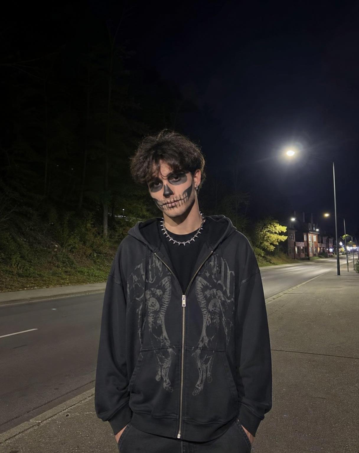 Create an ultra-realistic, candid Halloween night photograph of a young man with