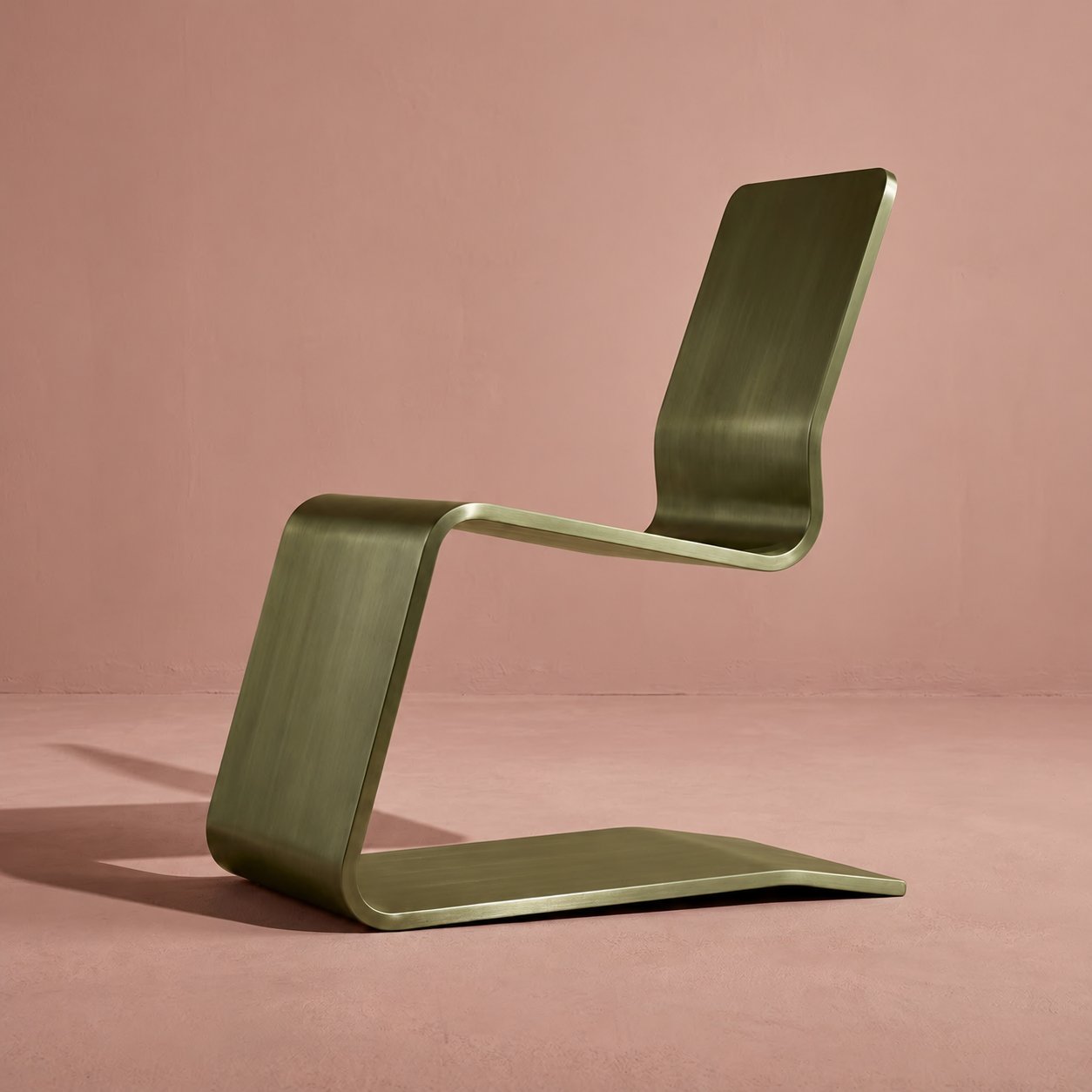 The ribbon chair rendered as brushed olive-green metal on a dusty rose floor, same side
view