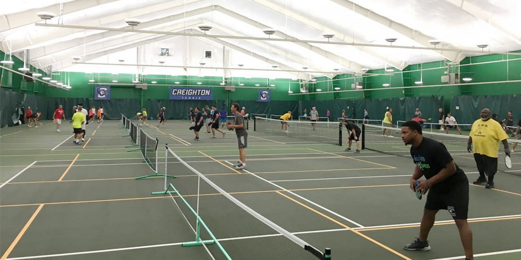 long shot of players competing on tennis court
