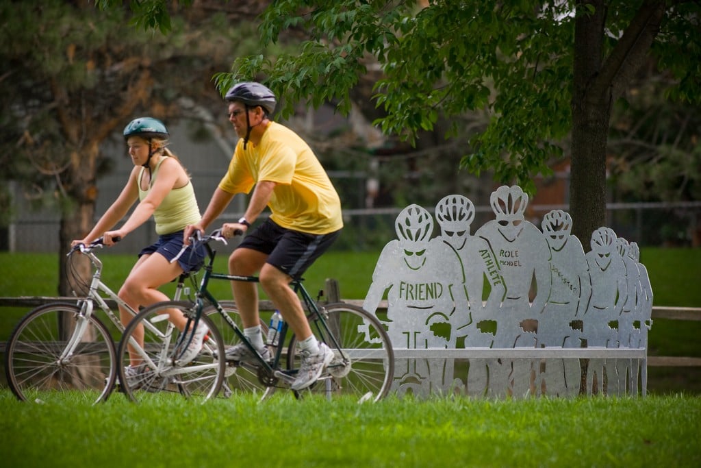 man and woman cycling beside display