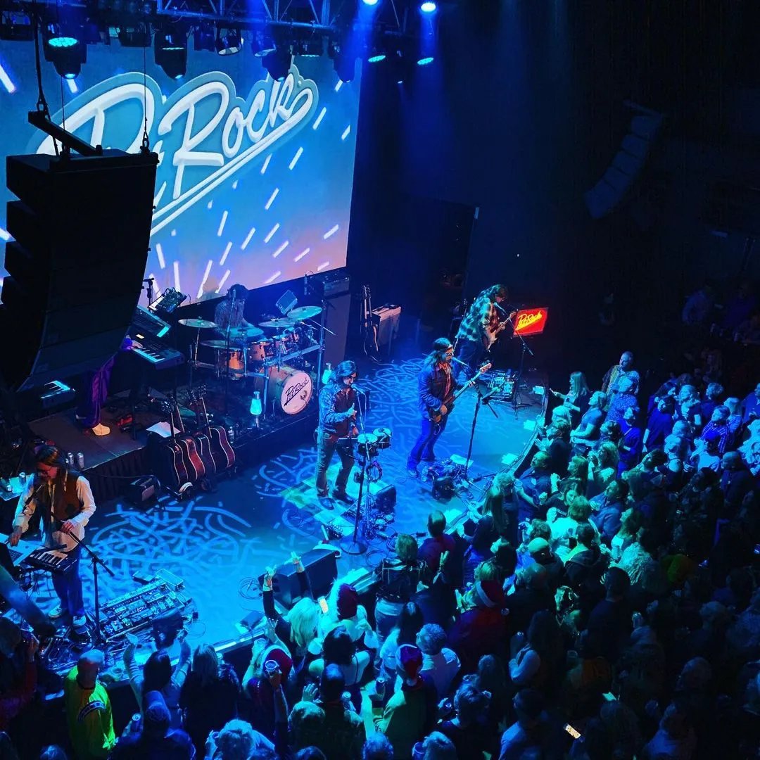 Band playing at the Slowdown venue with a packed crowd.