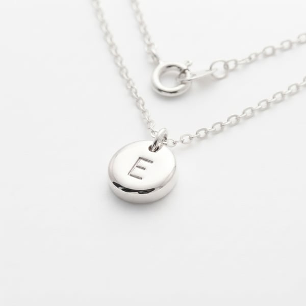 Three-quarter view — Mafaza Initial E Sterling Silver Pebble Necklace