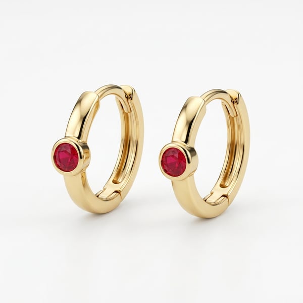 Pair of gold dainty ruby mini hoop earrings on a clean white background