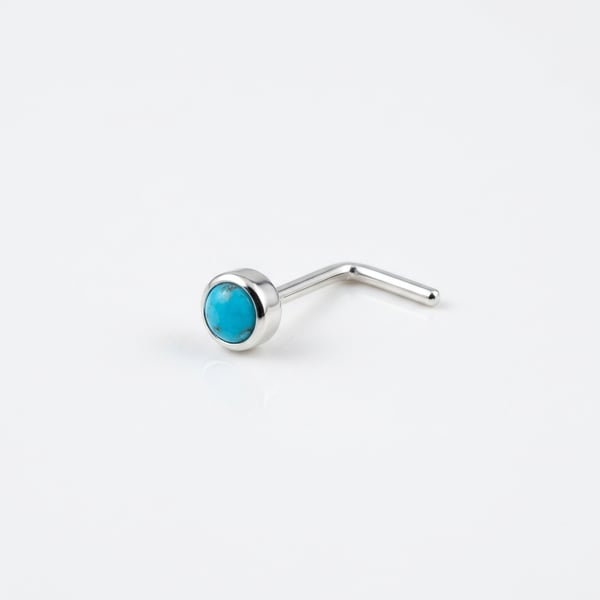Sterling silver nose stud set with a 3mm turquoise cabochon on a white background.
