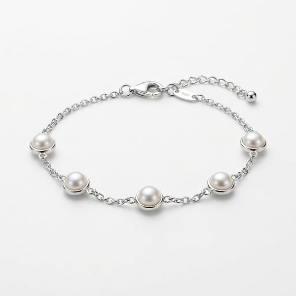 Studio shot of Areebah 925 sterling silver chain bracelet with five station-set round pearls on a plain white surface.