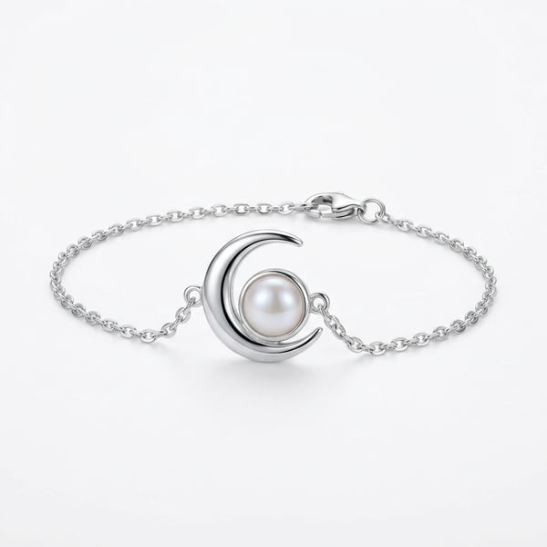 Sterling silver bracelet with crescent moon motif and white freshwater pearl on a plain white surface.