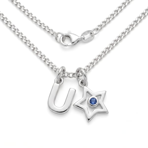 Sterling silver initial U pendant necklace with mini star charm and sapphire accent on white background.