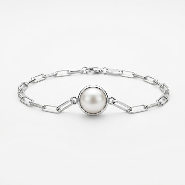 Nayla 925 sterling silver chain link bracelet with a single round white freshwater pearl on a white background.