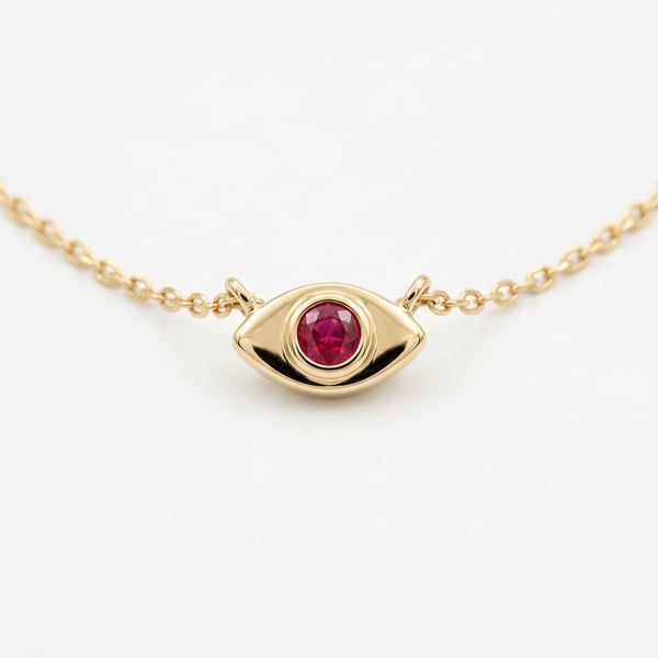 18K yellow gold evil eye necklace with a central 3mm ruby on a fine cable chain