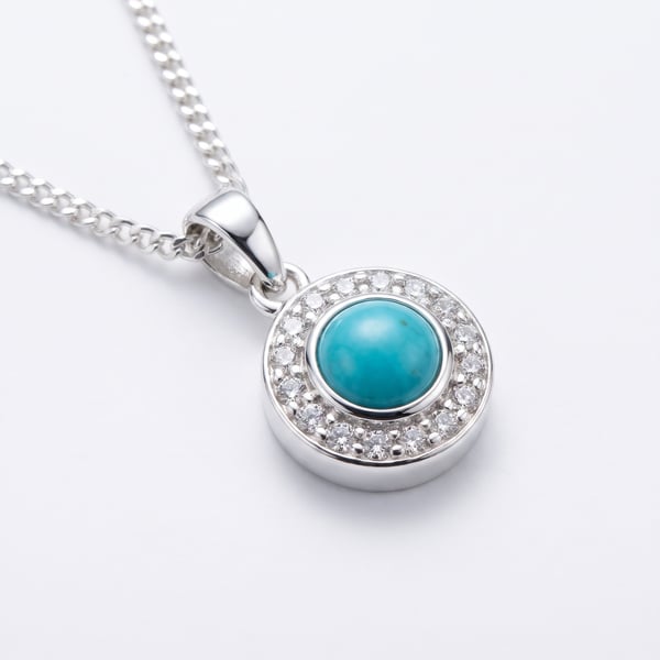 Fadi men's 925 sterling silver pendant featuring a round turquoise cabochon surrounded by a pavé halo on a silver chain.