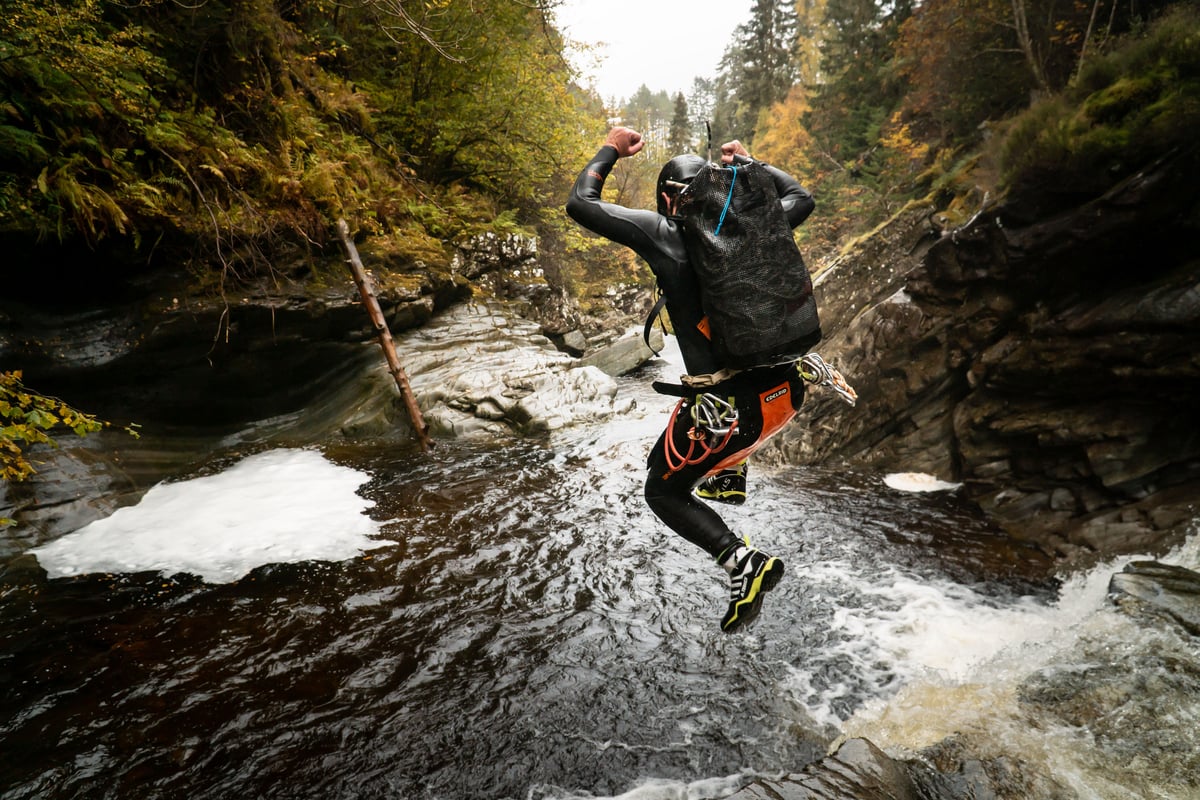 Canyoning group leap for joy on a Scottish canyoning adventure at Falls of Bruar, Pitlochry