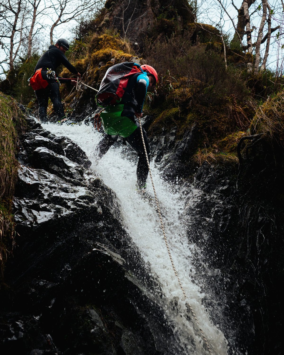 Their gift voucher redeemed, recipient enjoyes abseilng waterfall action on canyoning in Scotland experience