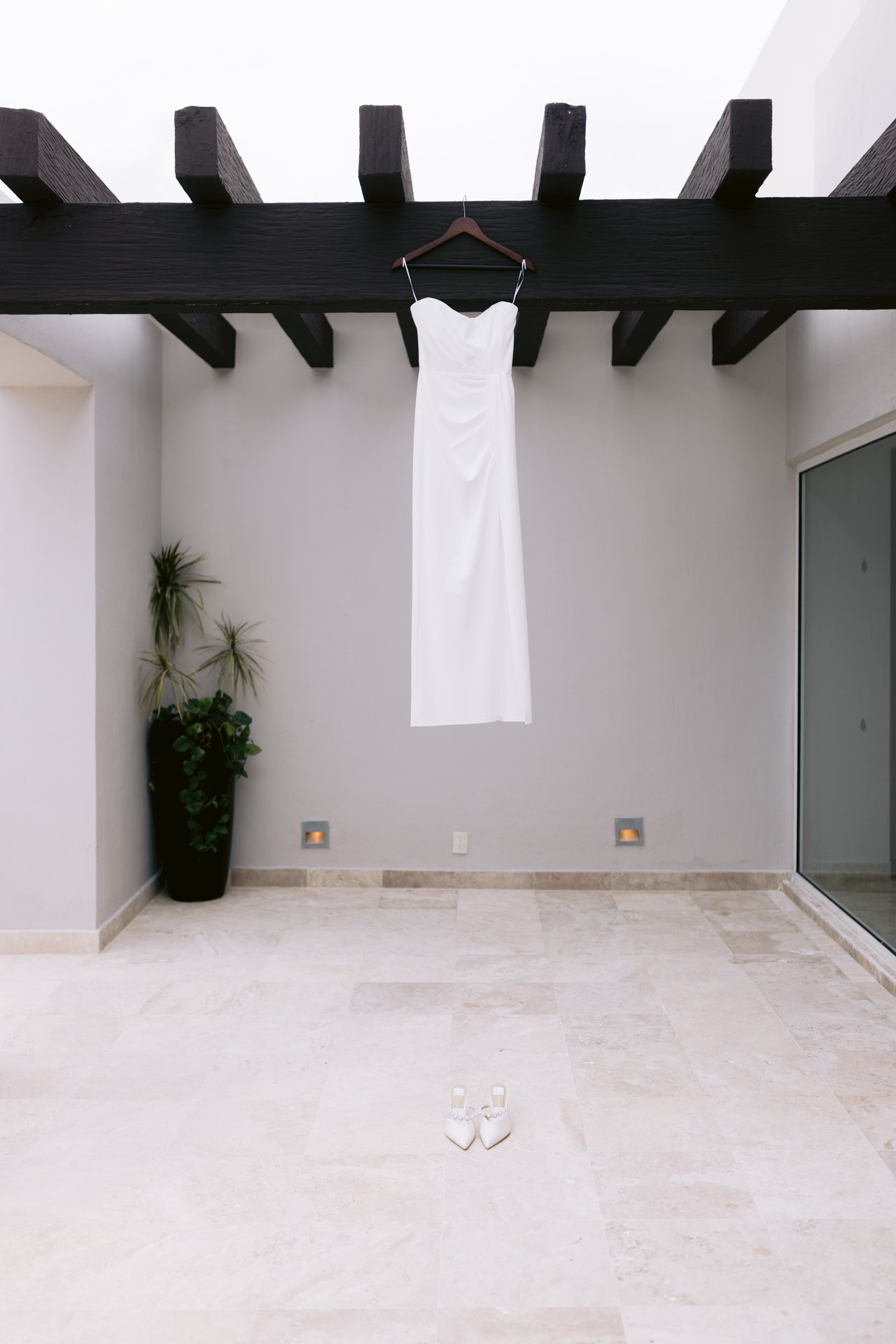 The dress hanging alone in a white courtyard at Dreams Jade Riviera Cancun