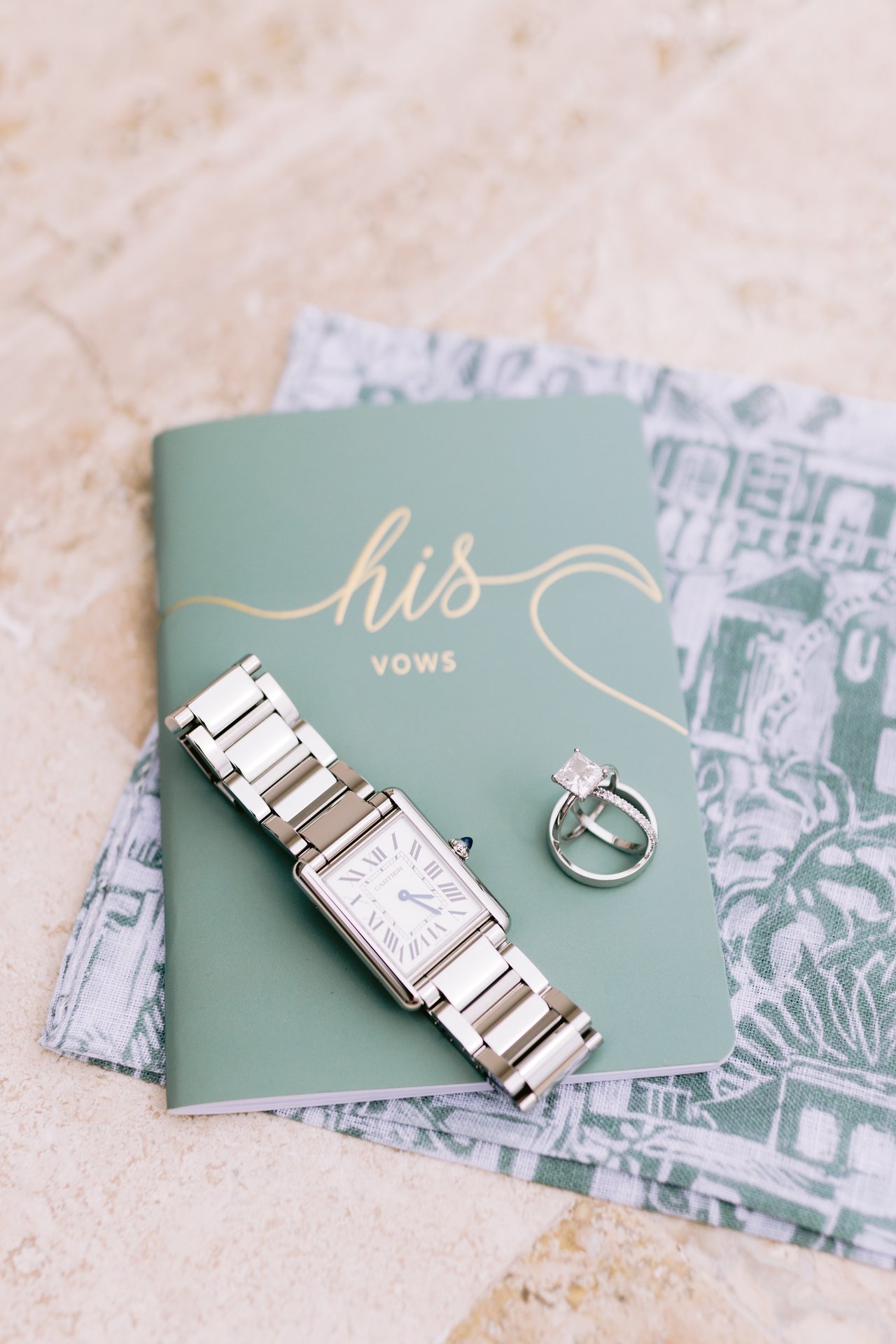 His vow book, rings, and watch laid out