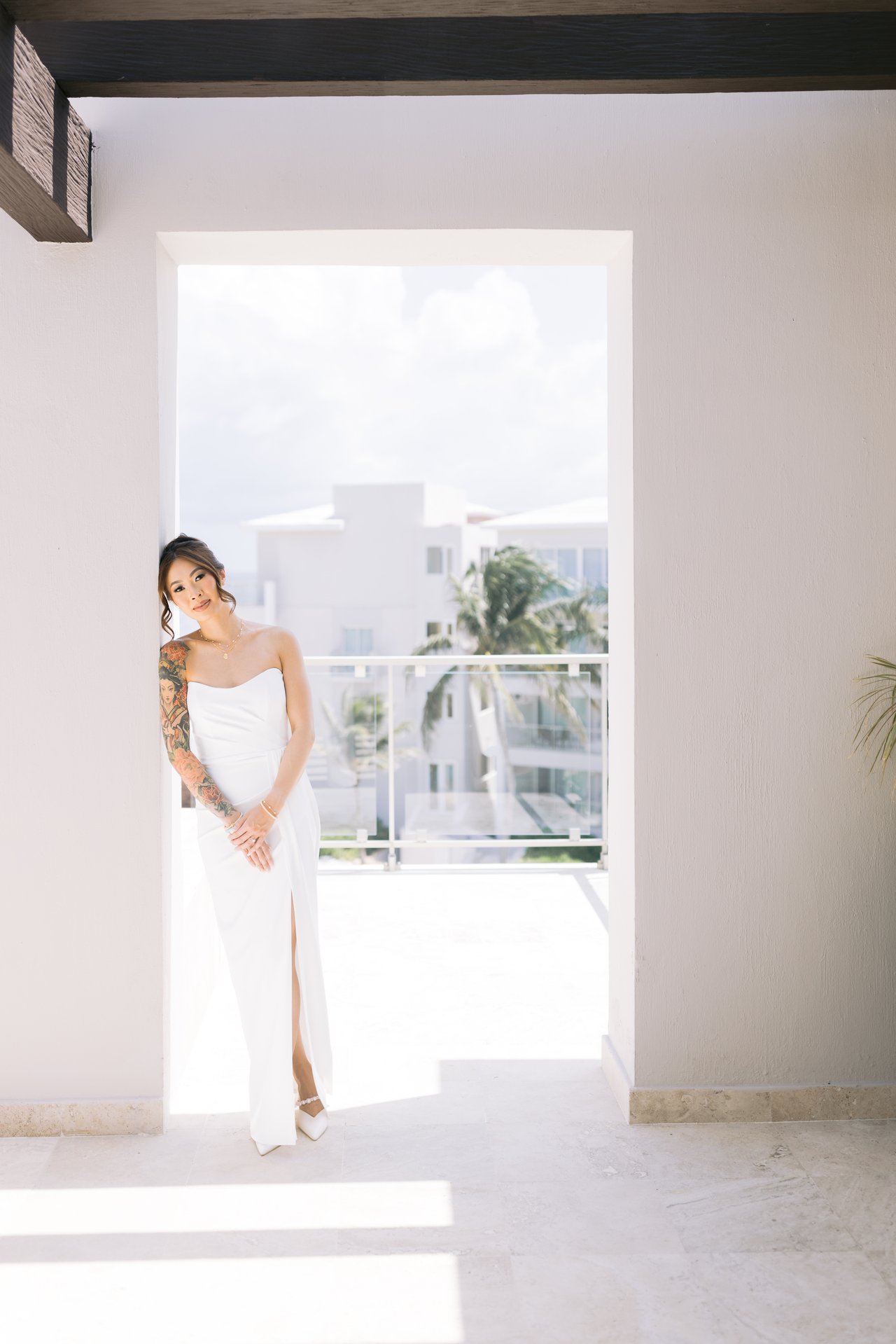 Iris in her dress in the suite doorway