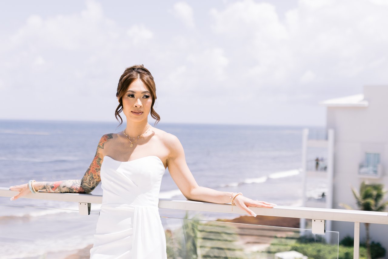 Iris on the balcony, the ocean behind her