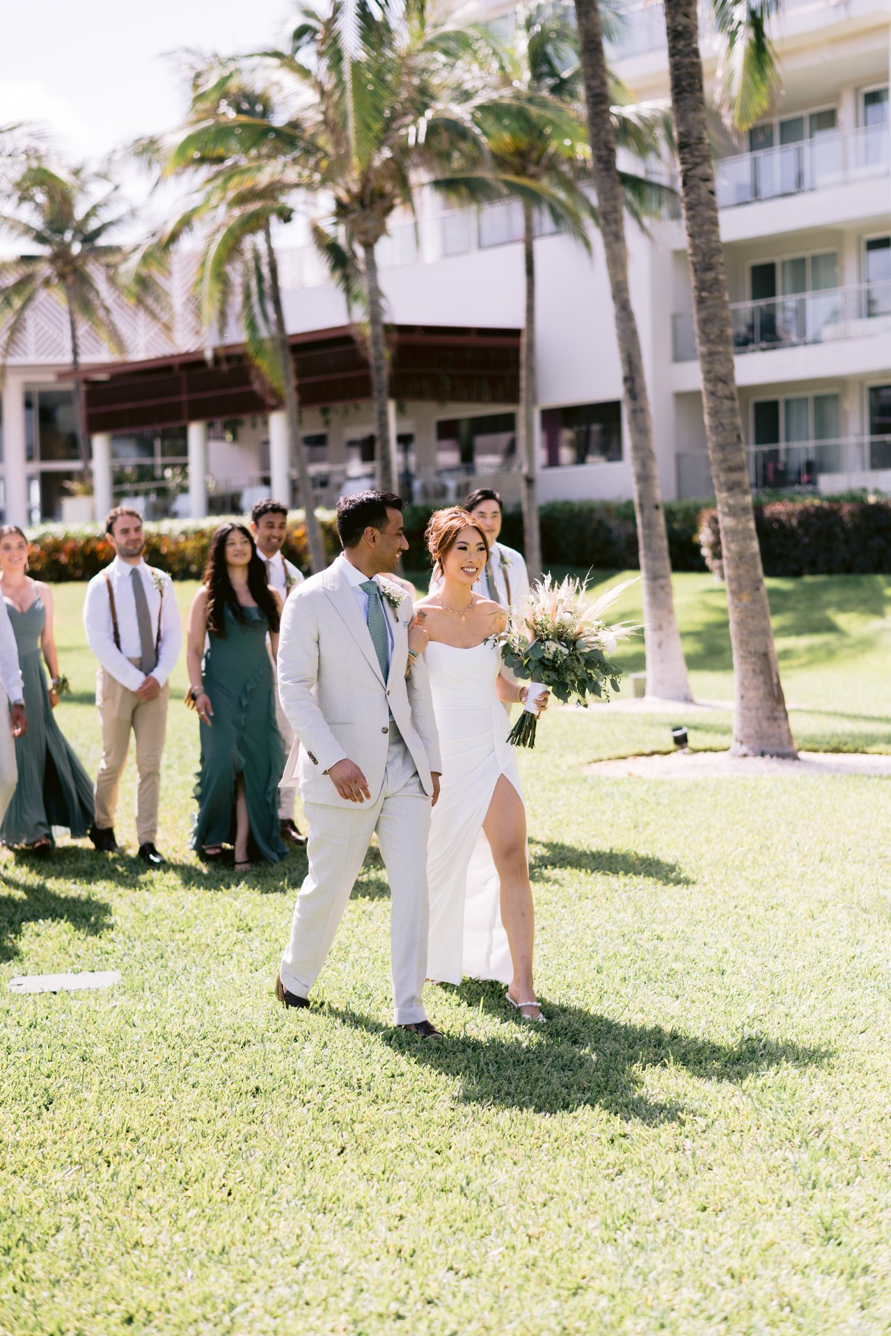 The wedding party crossing the lawn