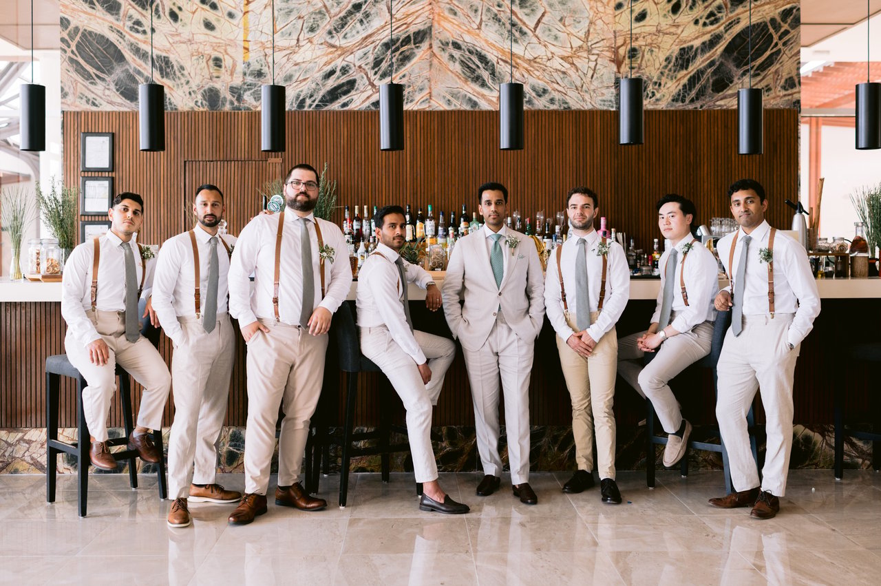 The groomsmen lined up on the lawn