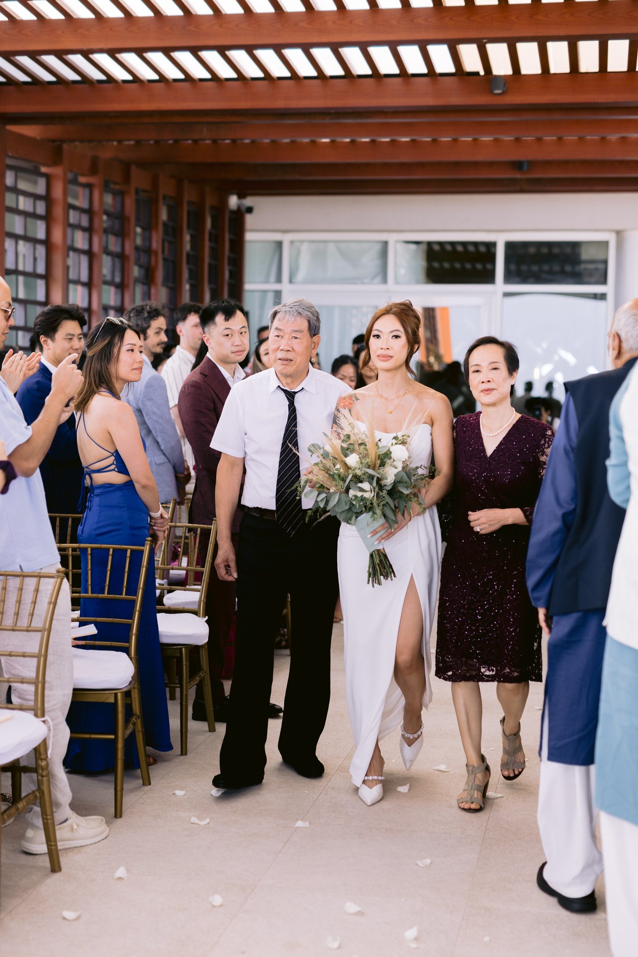 Iris walking down the aisle with her parents