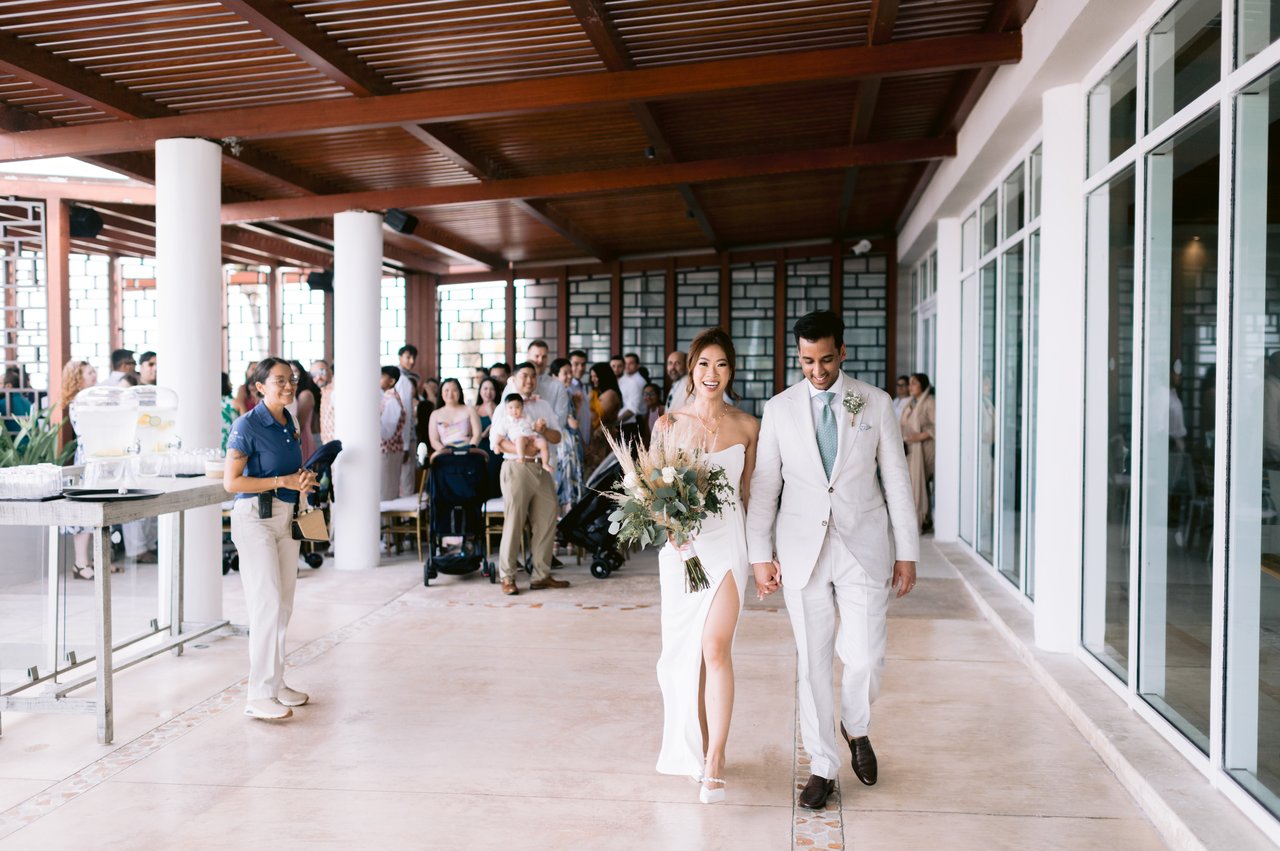 Leaving the ceremony through the reception hall