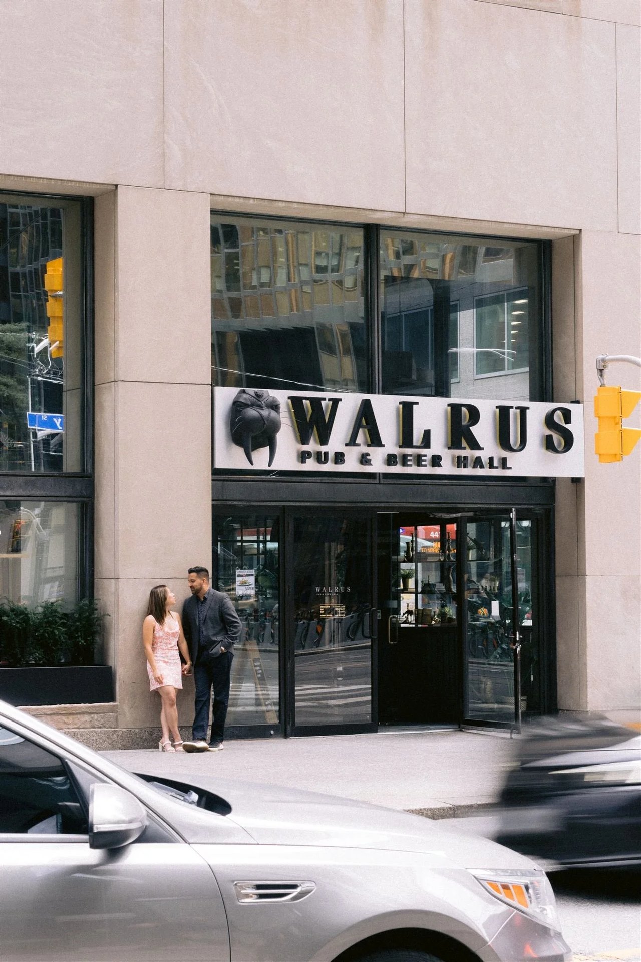 Midori and Adil outside The Walrus pub downtown, where they had their first date