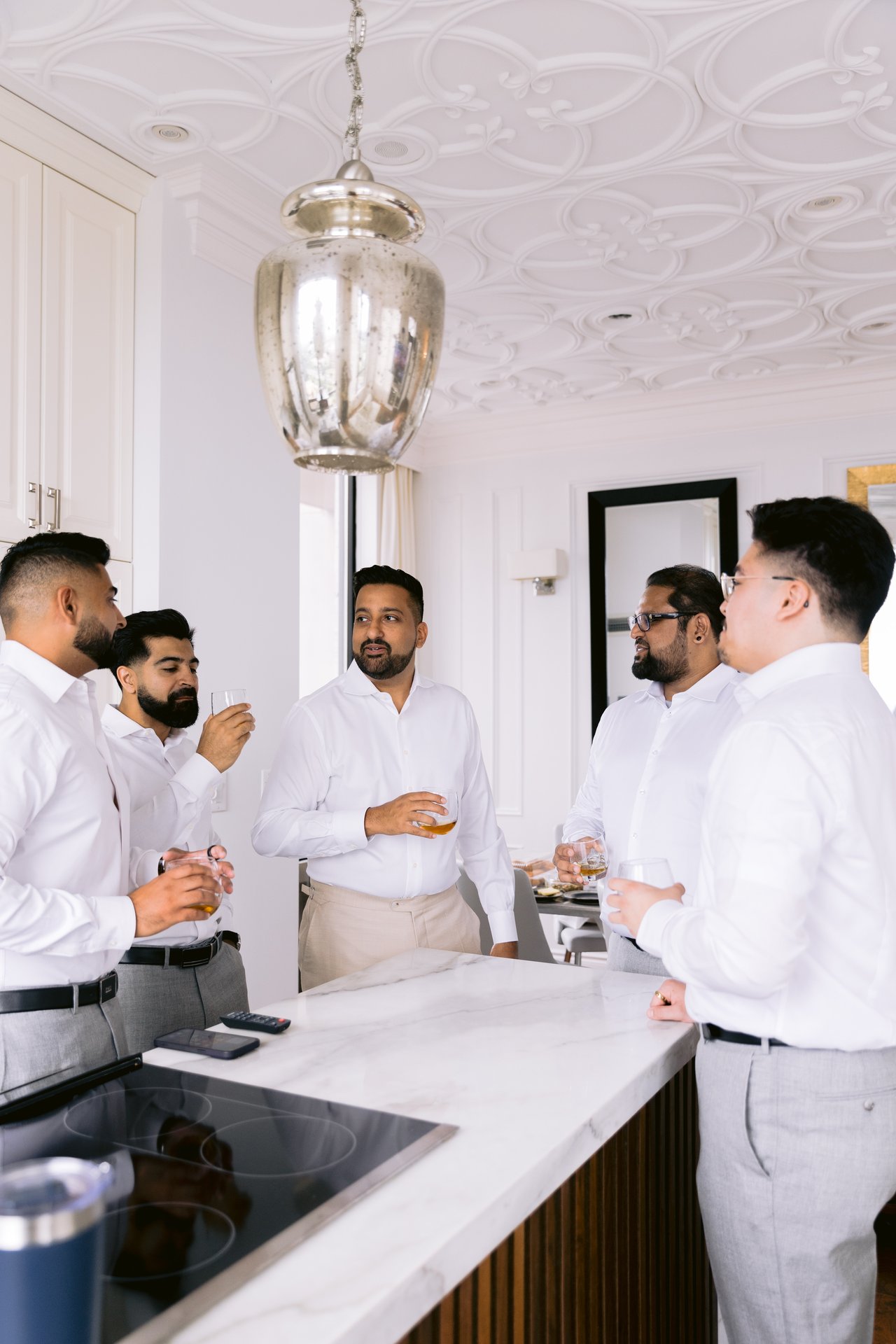 The groomsmen getting ready together in the kitchen