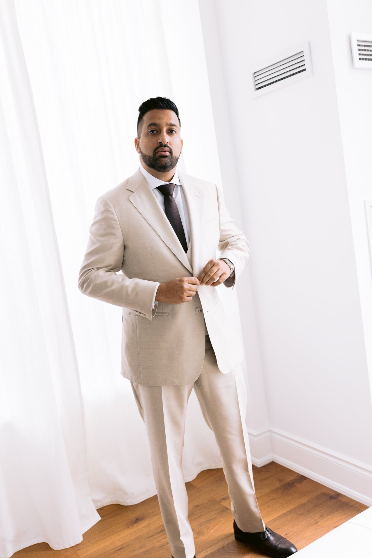 Adil in his beige suit before the first look