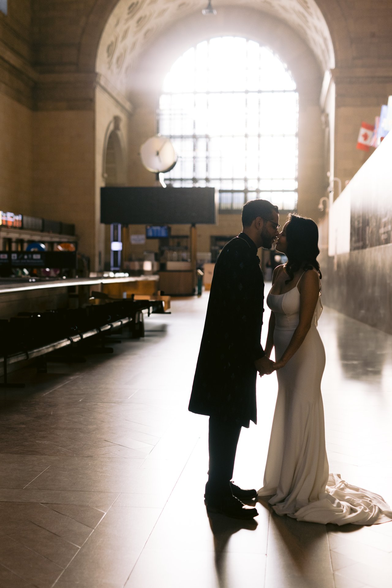 The couple silhouetted in the arches of Union Station