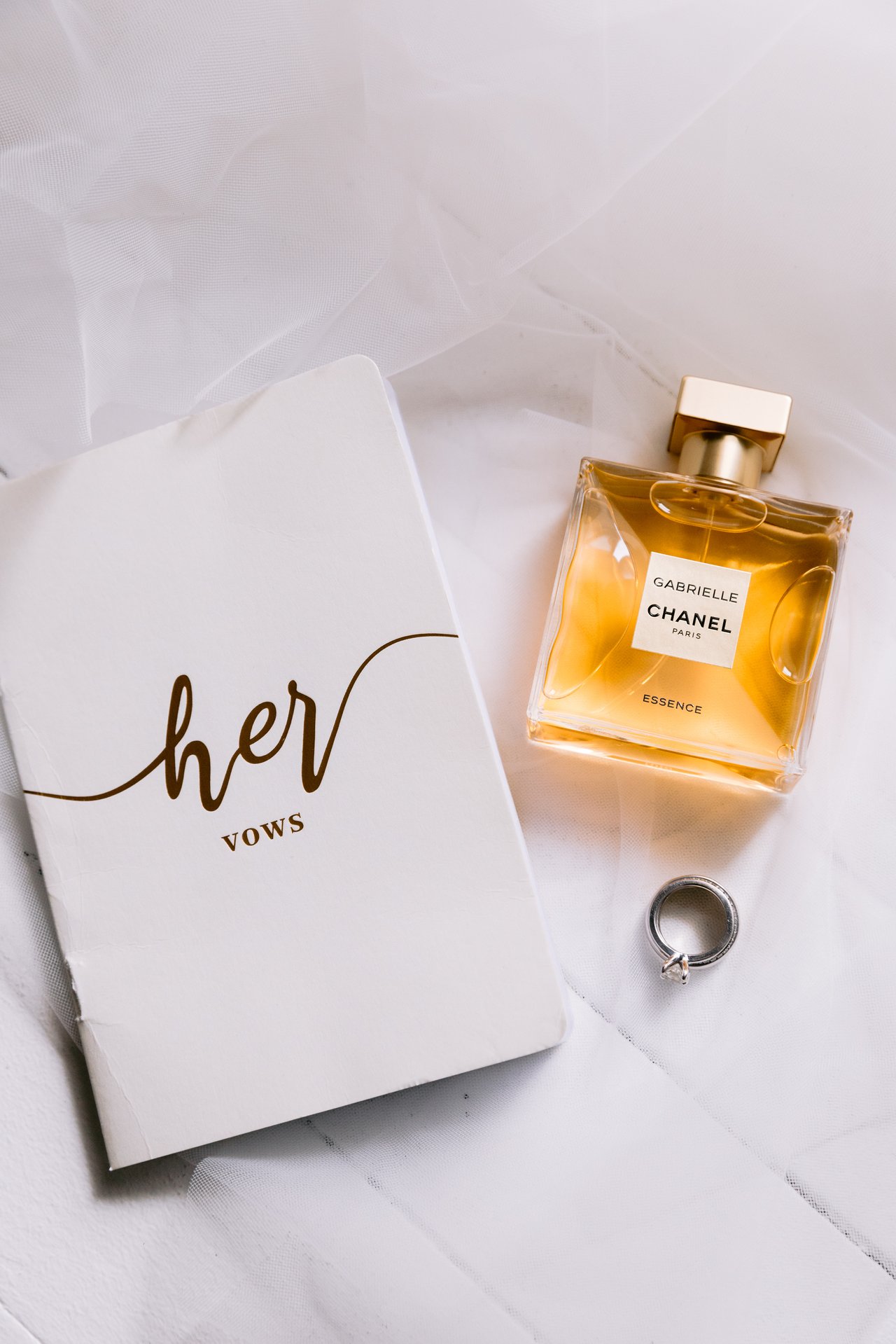Her vow book, Chanel No.&nbsp;5, and the ring on white marble