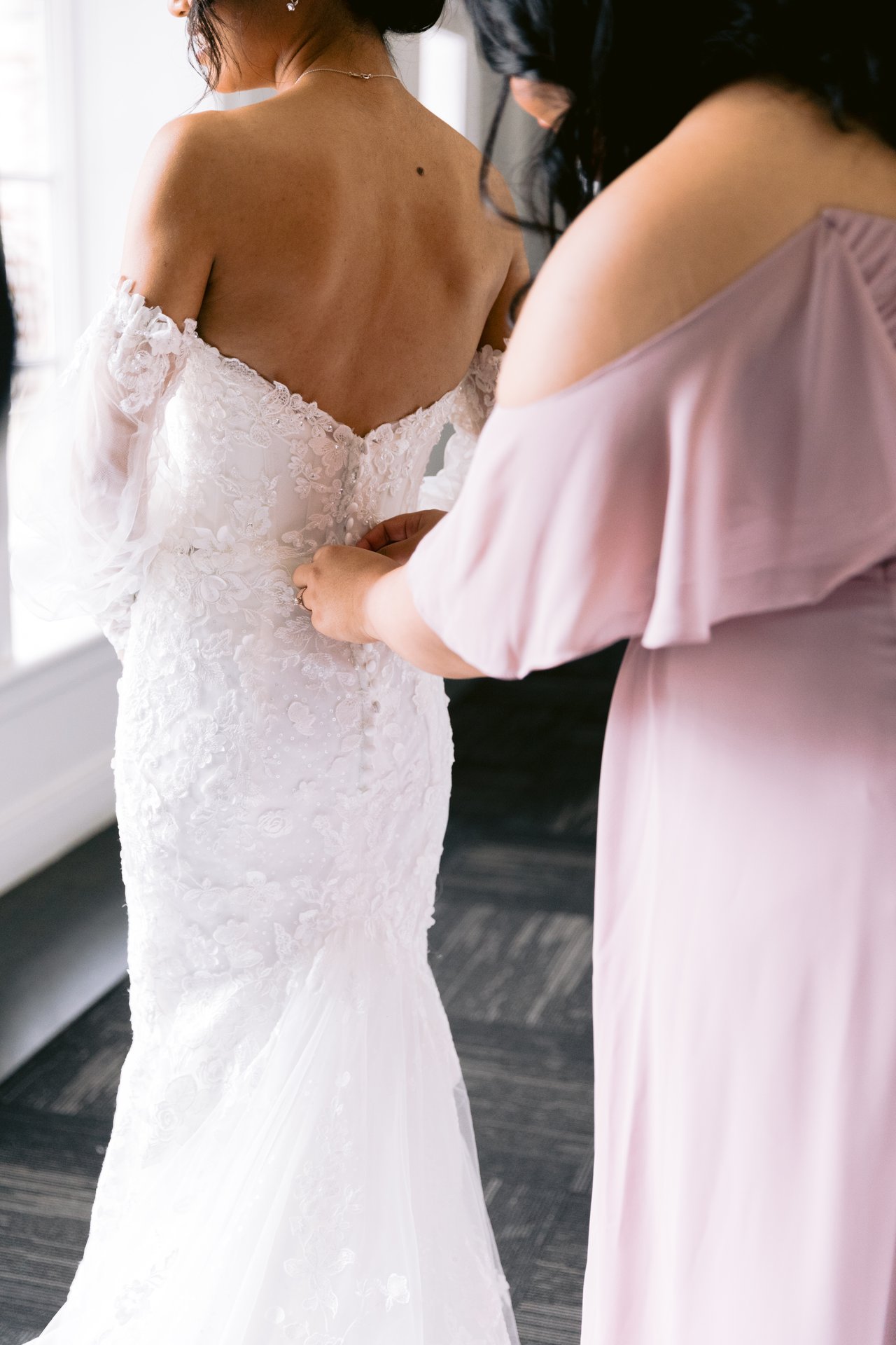 Adjusting the gown at the window