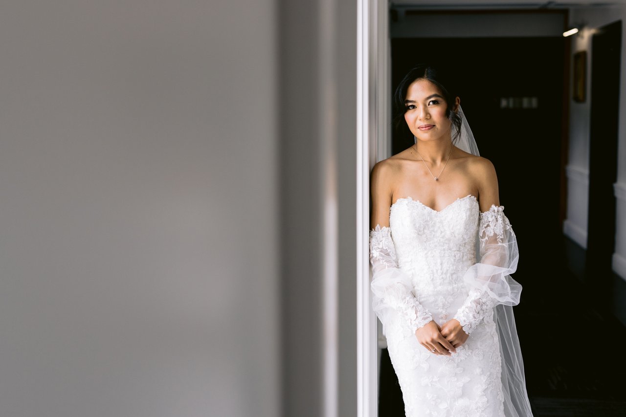Kat in the bright hallway, the gown trailing
