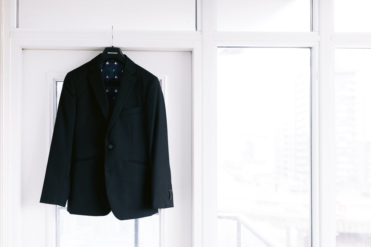 His jacket on the hanger by the window
