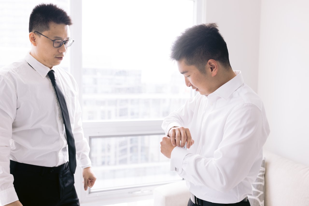 A groomsman with the cufflinks at the window