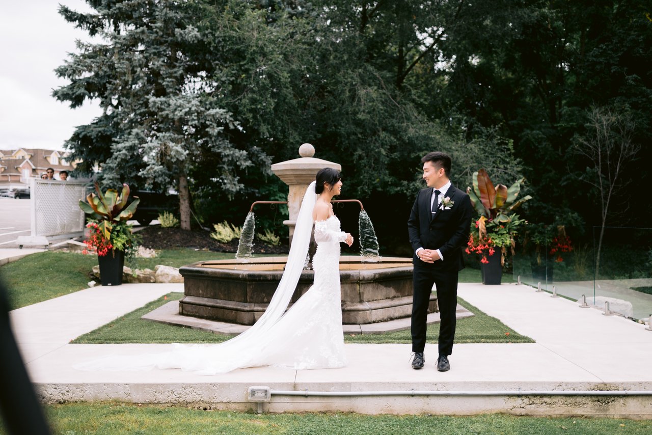 By the stone fountain, autumn florals behind them