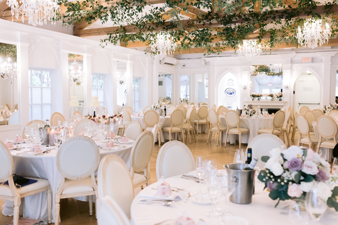 The room, greenery running the length of the head table
