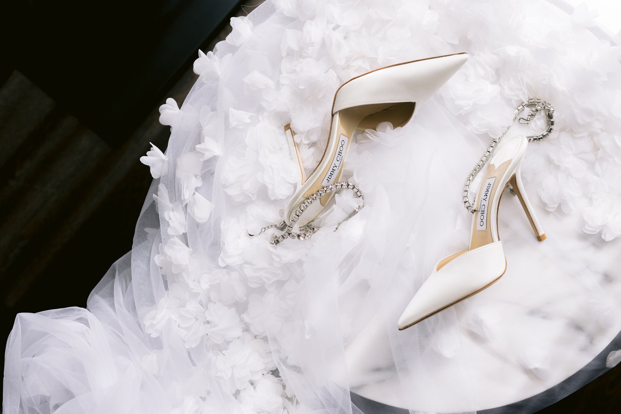 The shoes resting on the gown and its florals